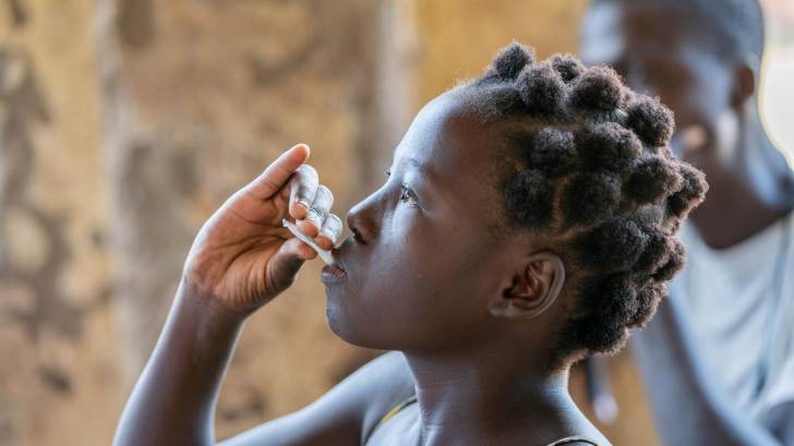 young african being given cholera vaccine