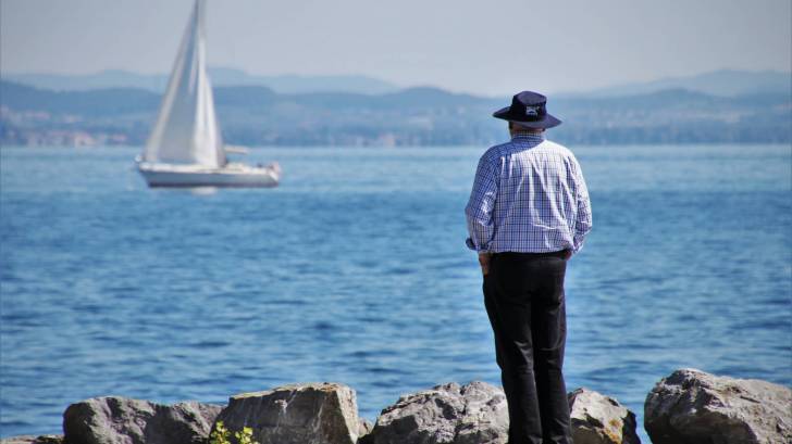 old man looking at the lake