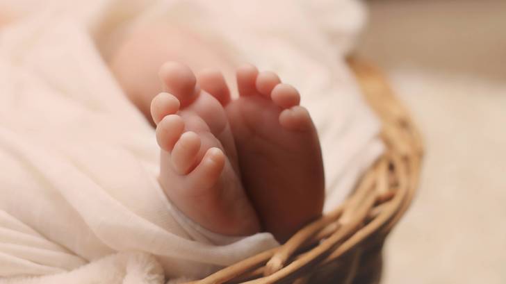 new born baby feet in a basket