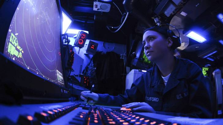 sailor working on a ship computer screens