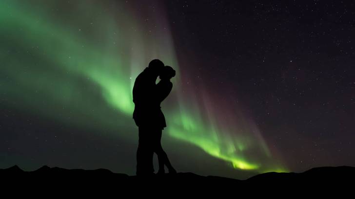 couple in front of northern lights