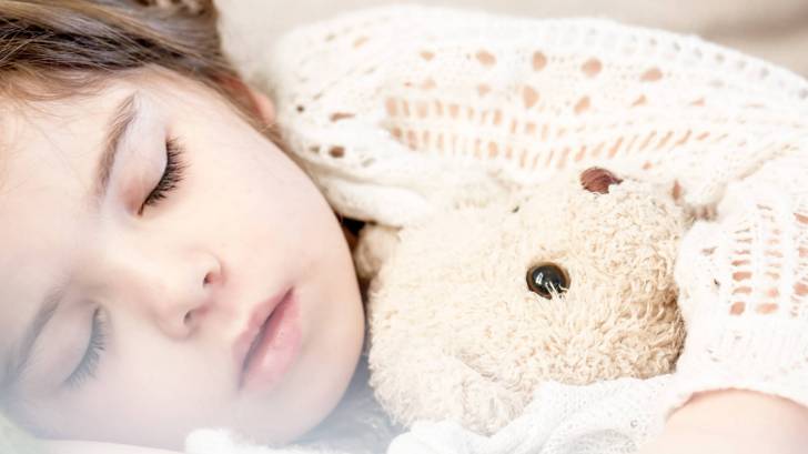 young sleeping little girl with Teddy bear