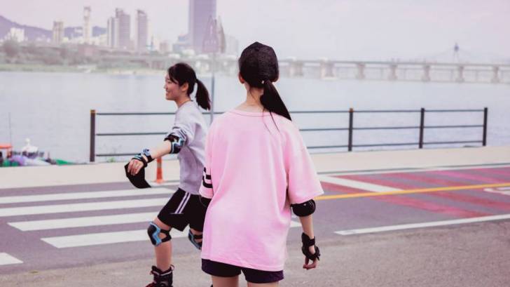 two young girls roller blading