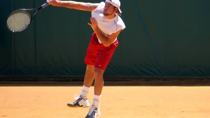 tennis player on red clay court