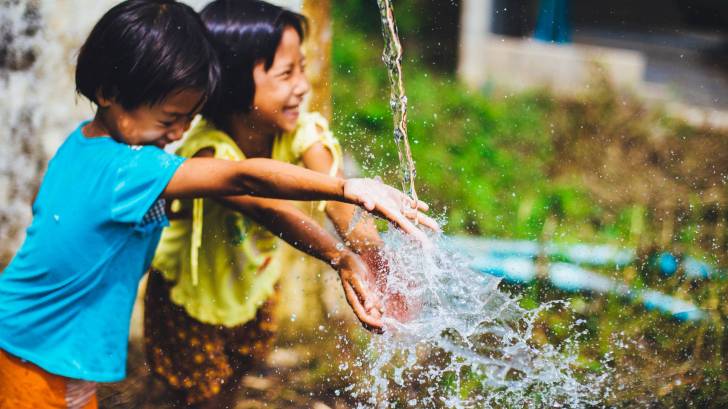children playing with running water