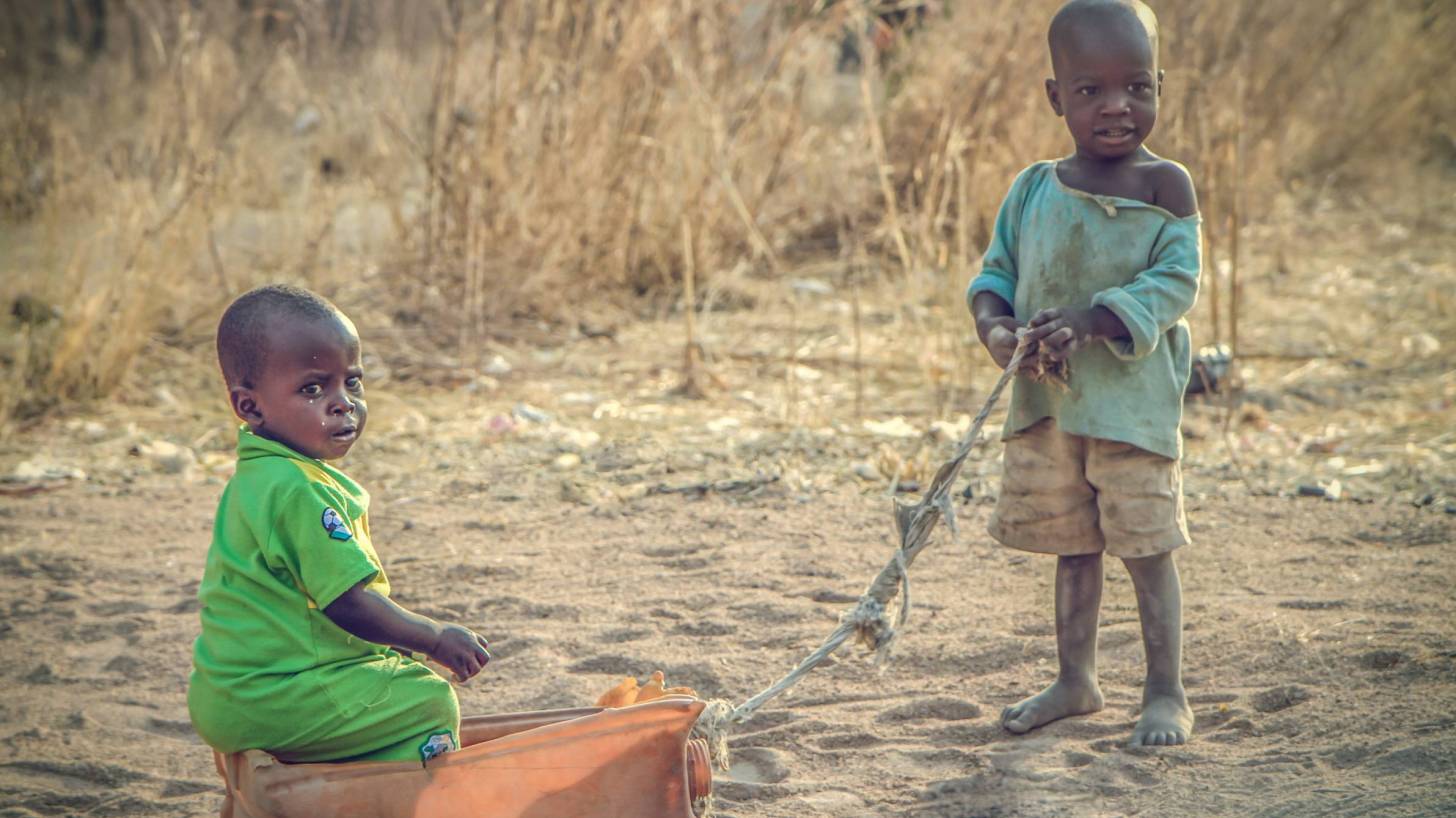 young children in africa playing with a box