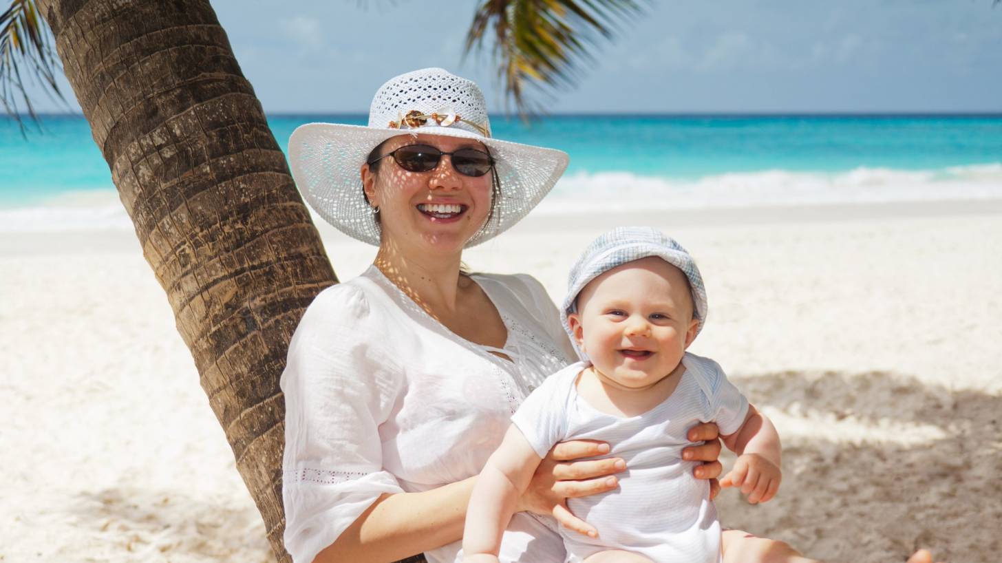 mom and happy baby on a beach
