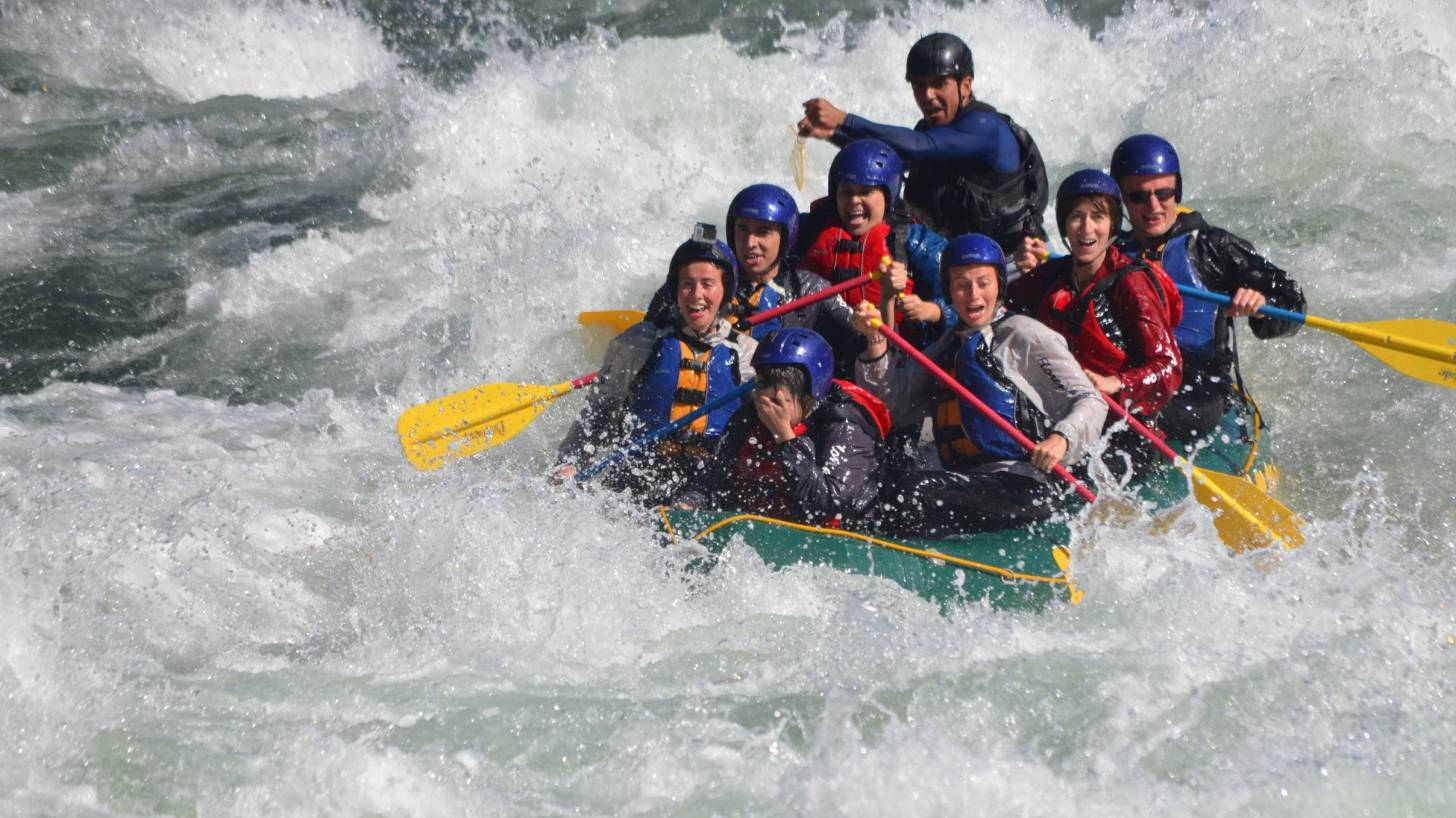 teamwork on a boat in the rapids