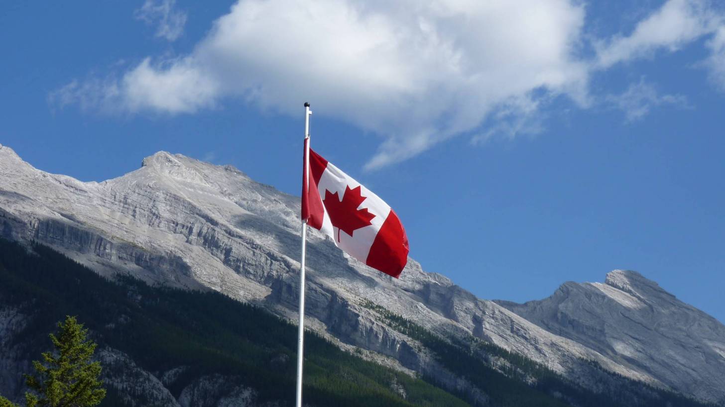 canadian flag over the mountains