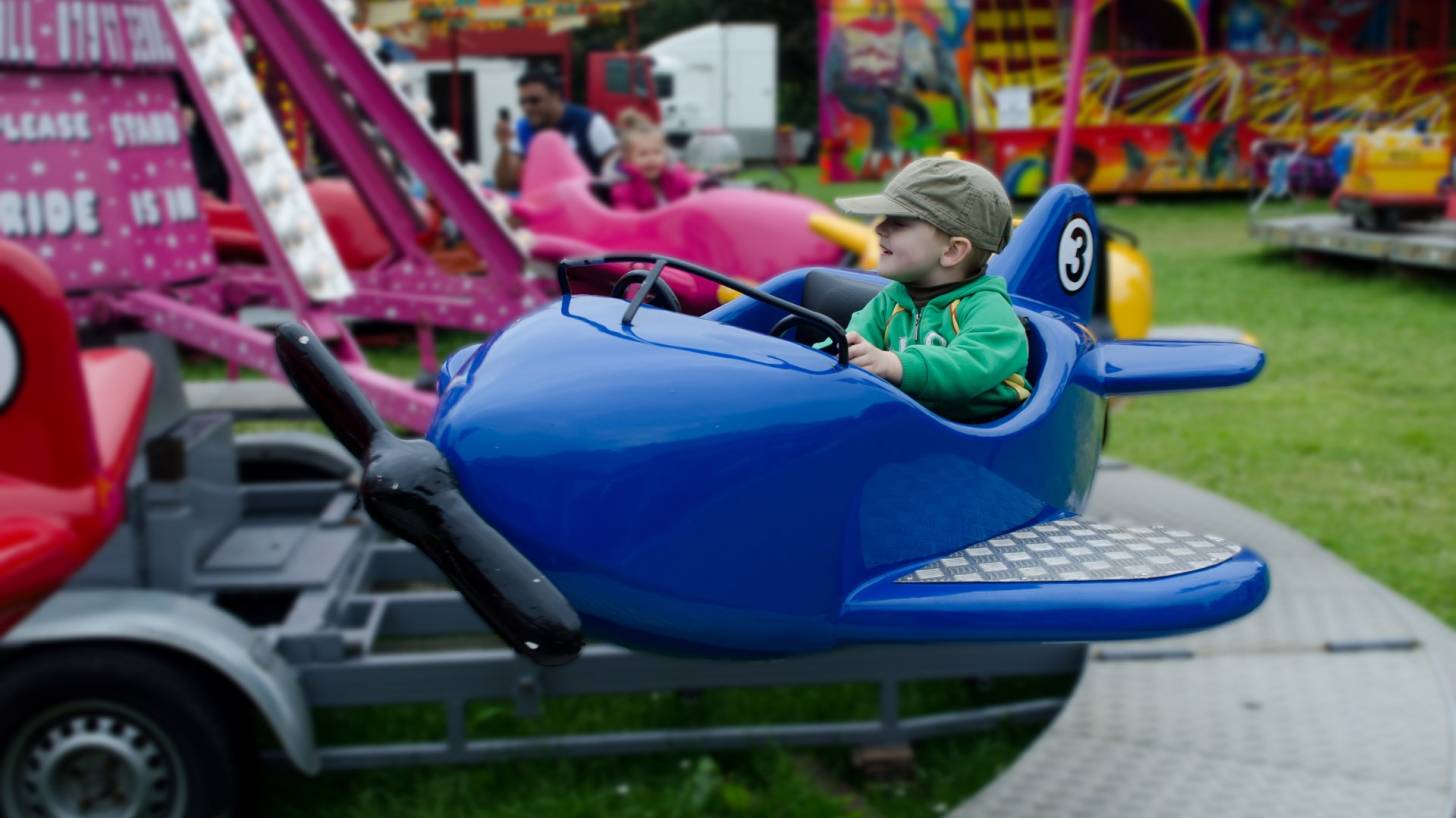 child riding a toy plane