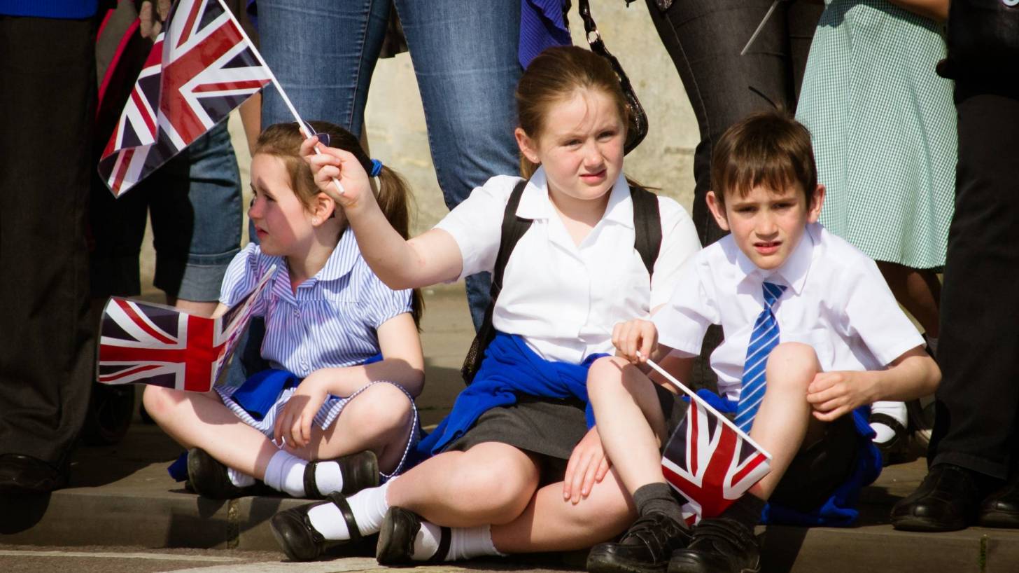young kids watching a parade in the UK