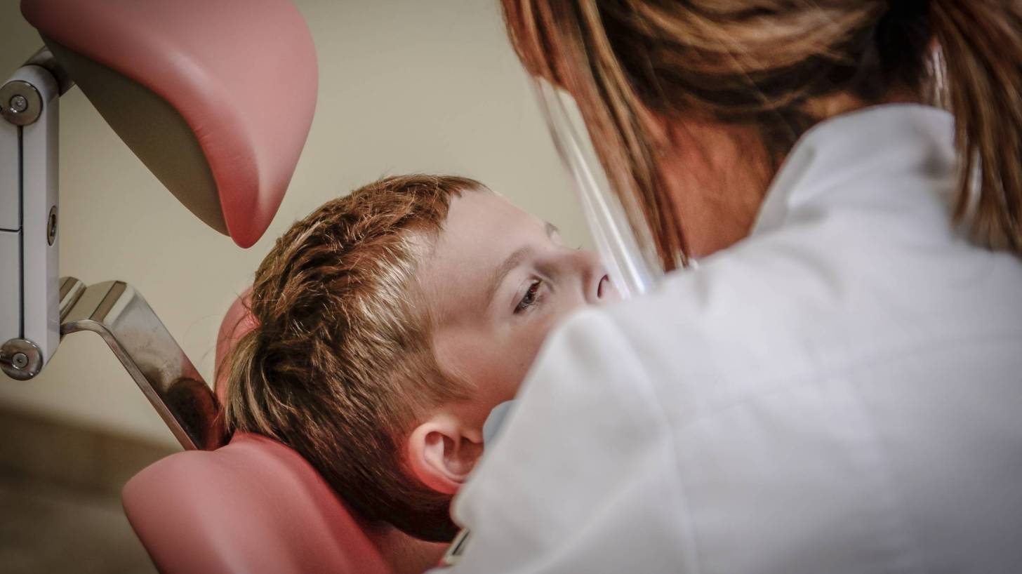 dentist with young boy in the chair