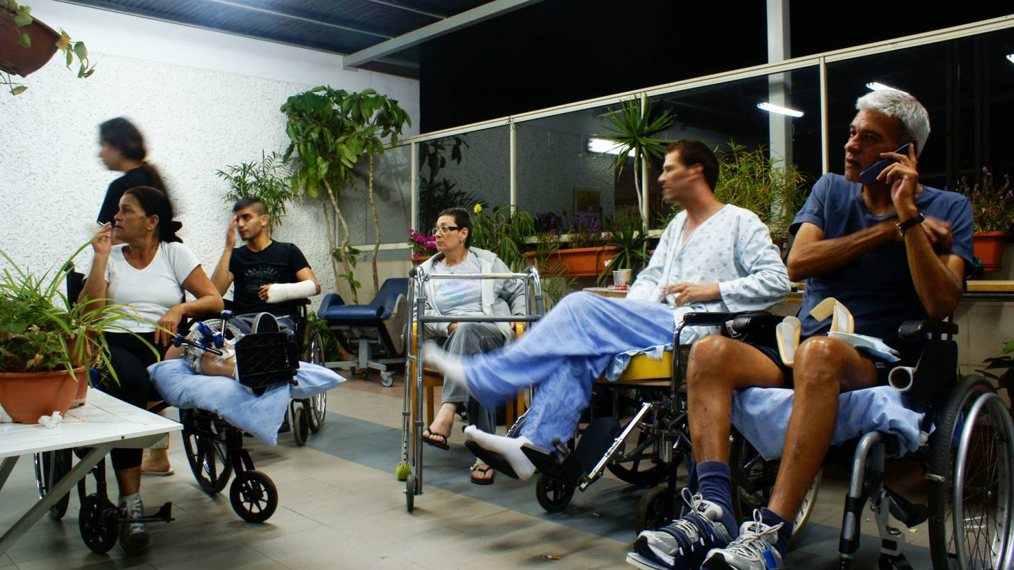 people in hospital, wheel chairs, smokinig