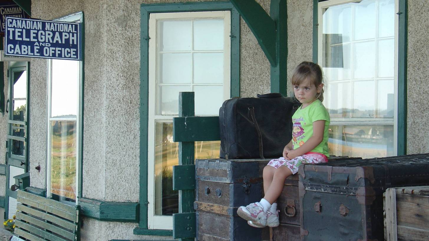 young girl at a train station