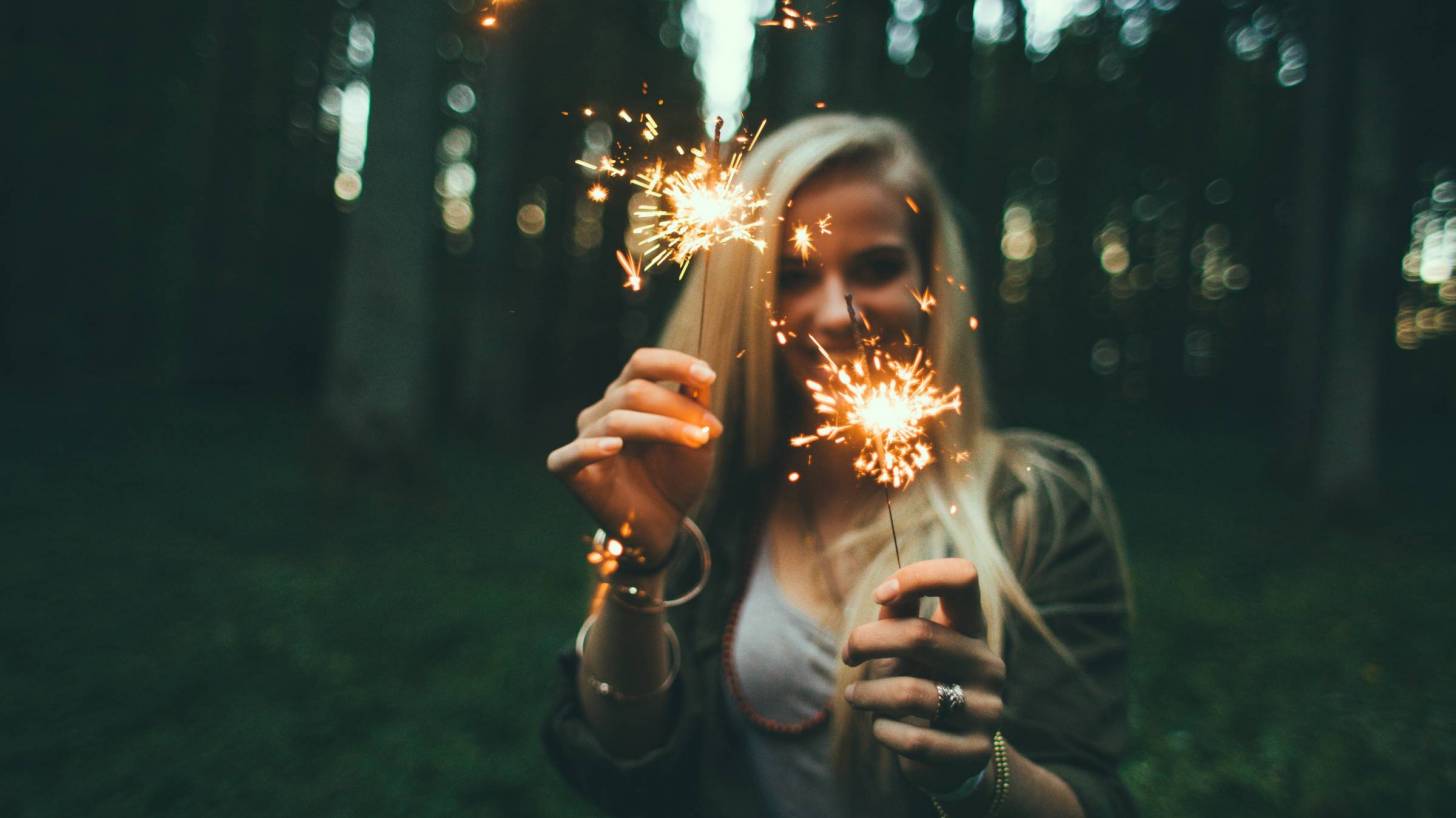 girl with sparklers celebrating