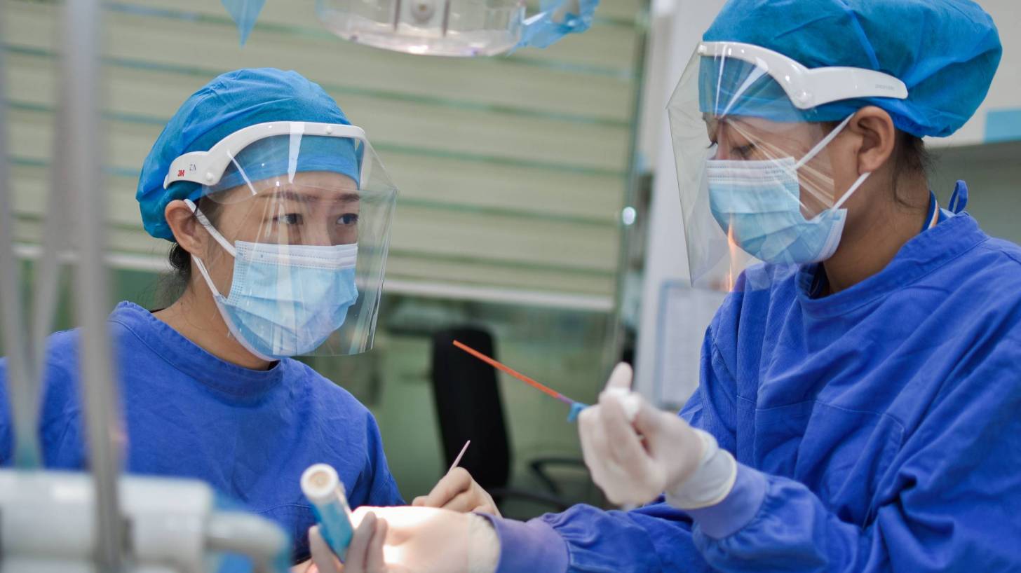 two doctors working with face shield protection