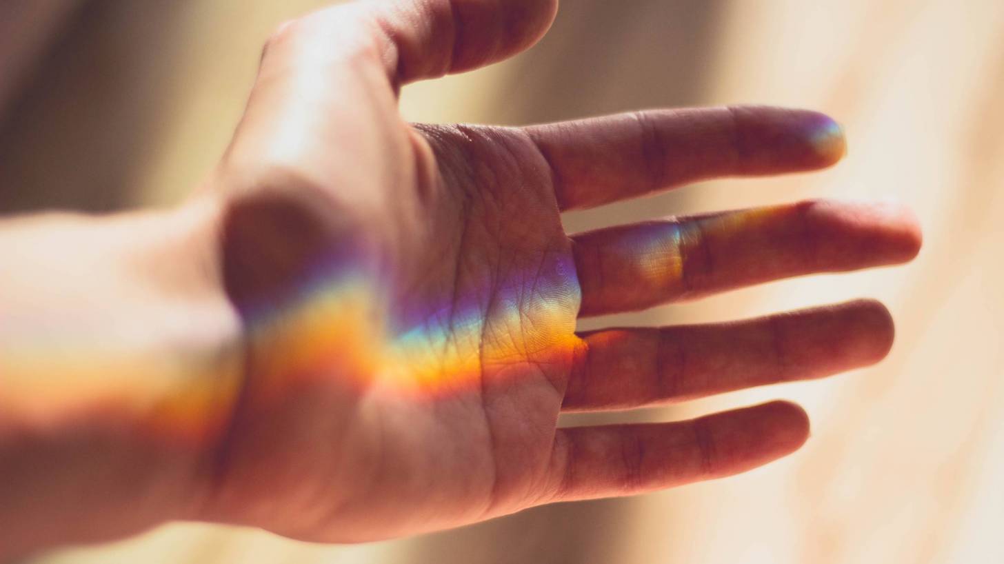 rainbow light on a hand