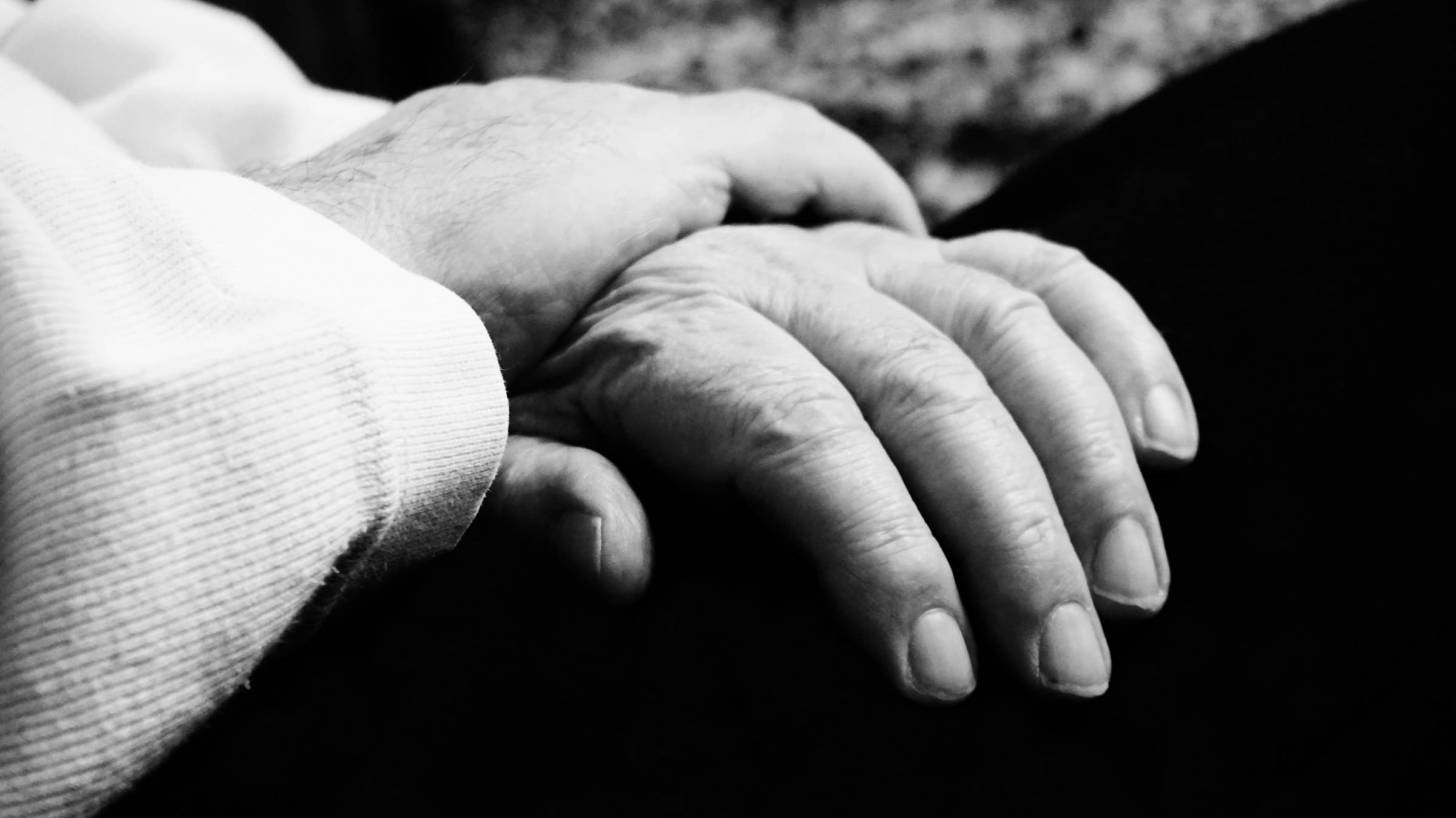 older person hand in lap
