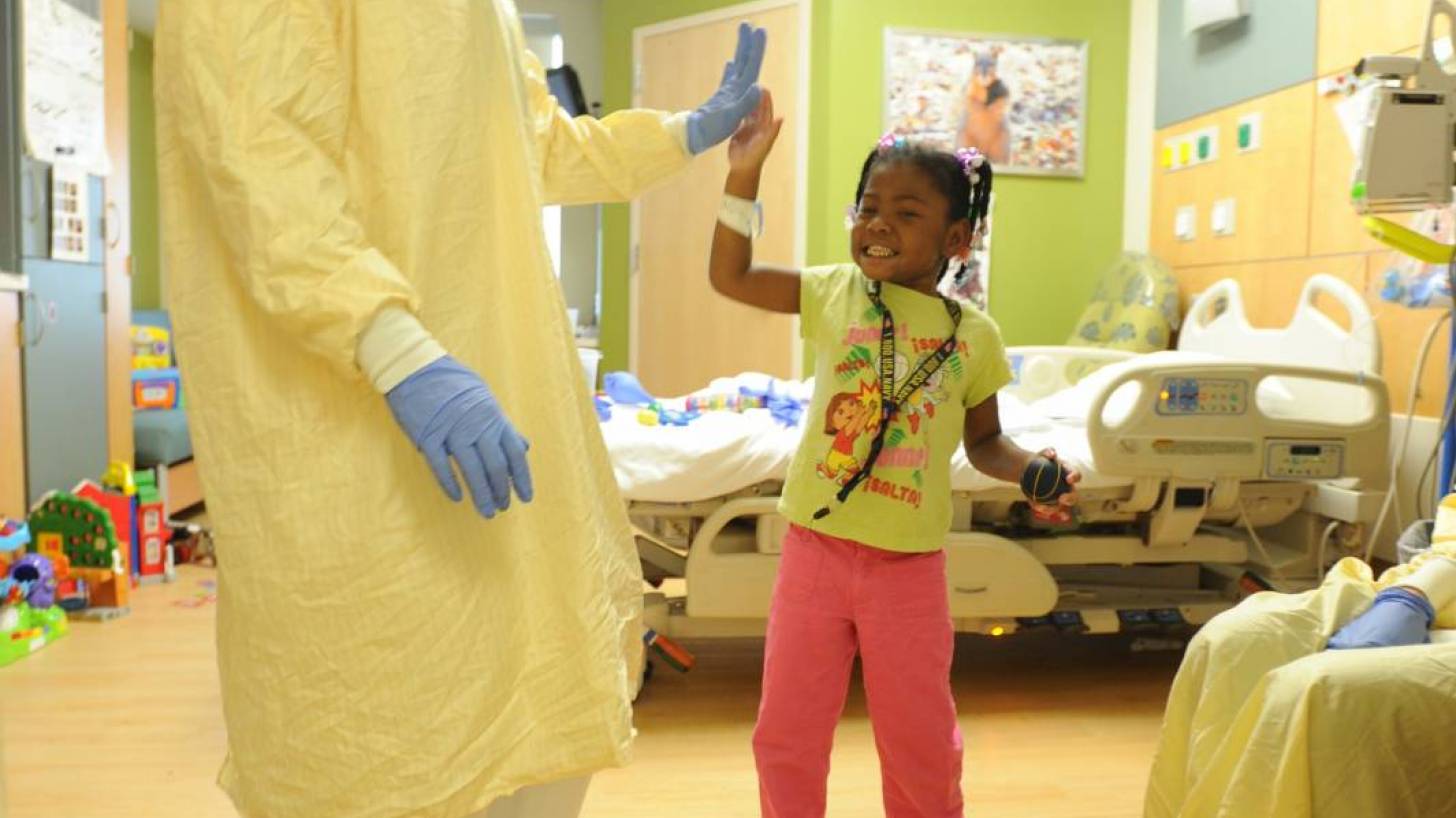 hospital nurse with patient little girl