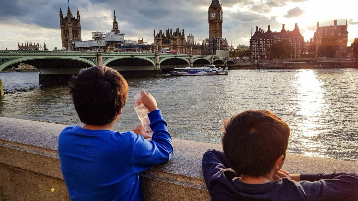 two young children looking at the city of london