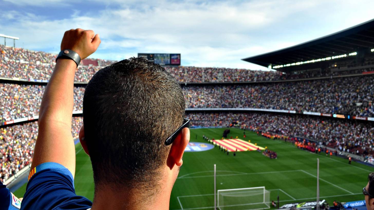 man cheering at the barcelona football stadium