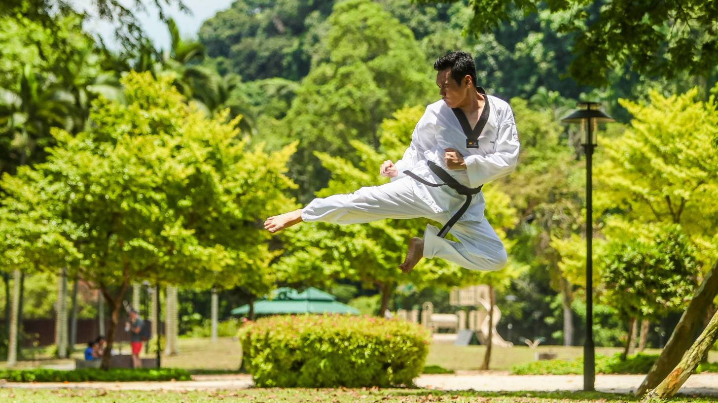 karate student high in the air, kicking