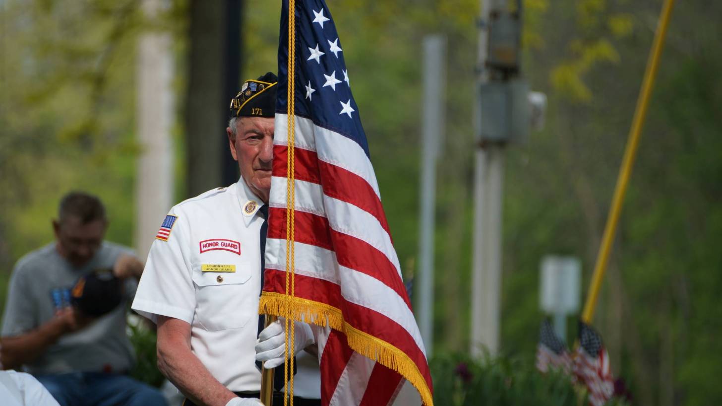 honor guard older vet with flag