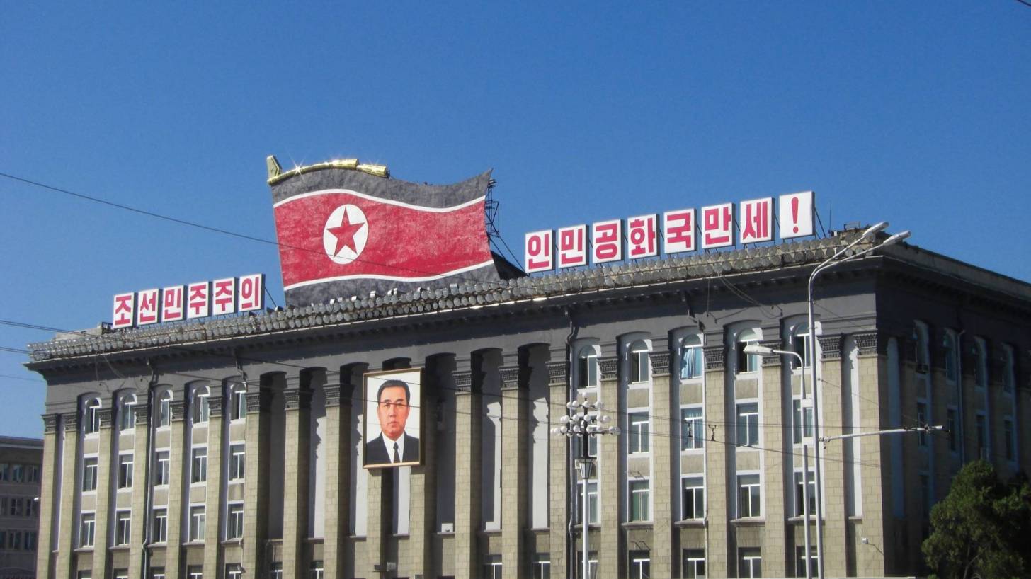 north korea building with flag