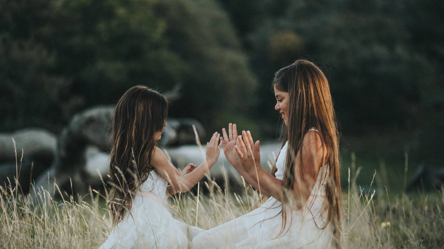 two young girls playing in a field