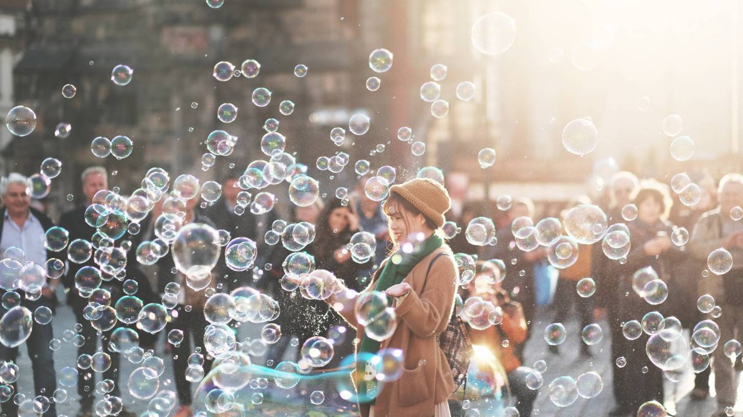crowd of people in street with bubbles representing flu germs