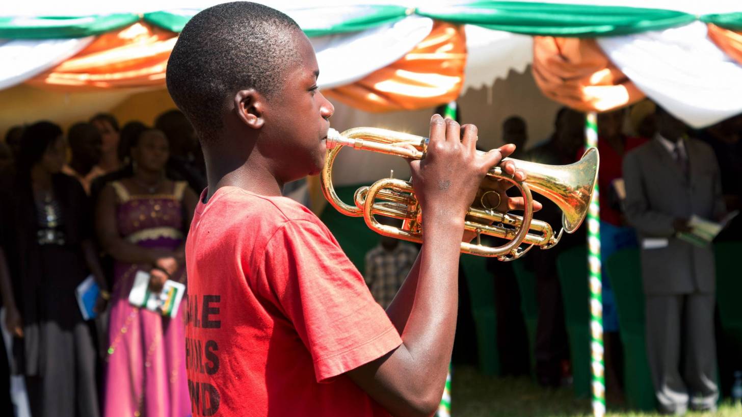 young black boy playing the bugle