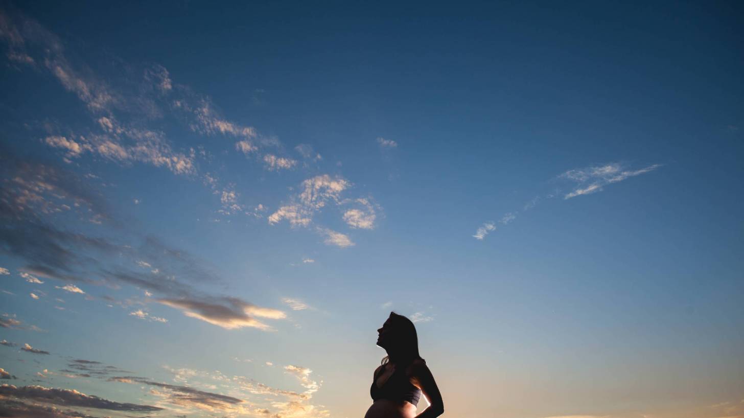 pregnant woman looking at beautiful florida sky