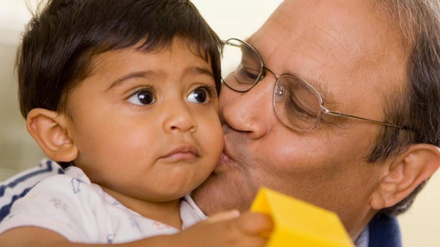 Grandpa kissing grandson