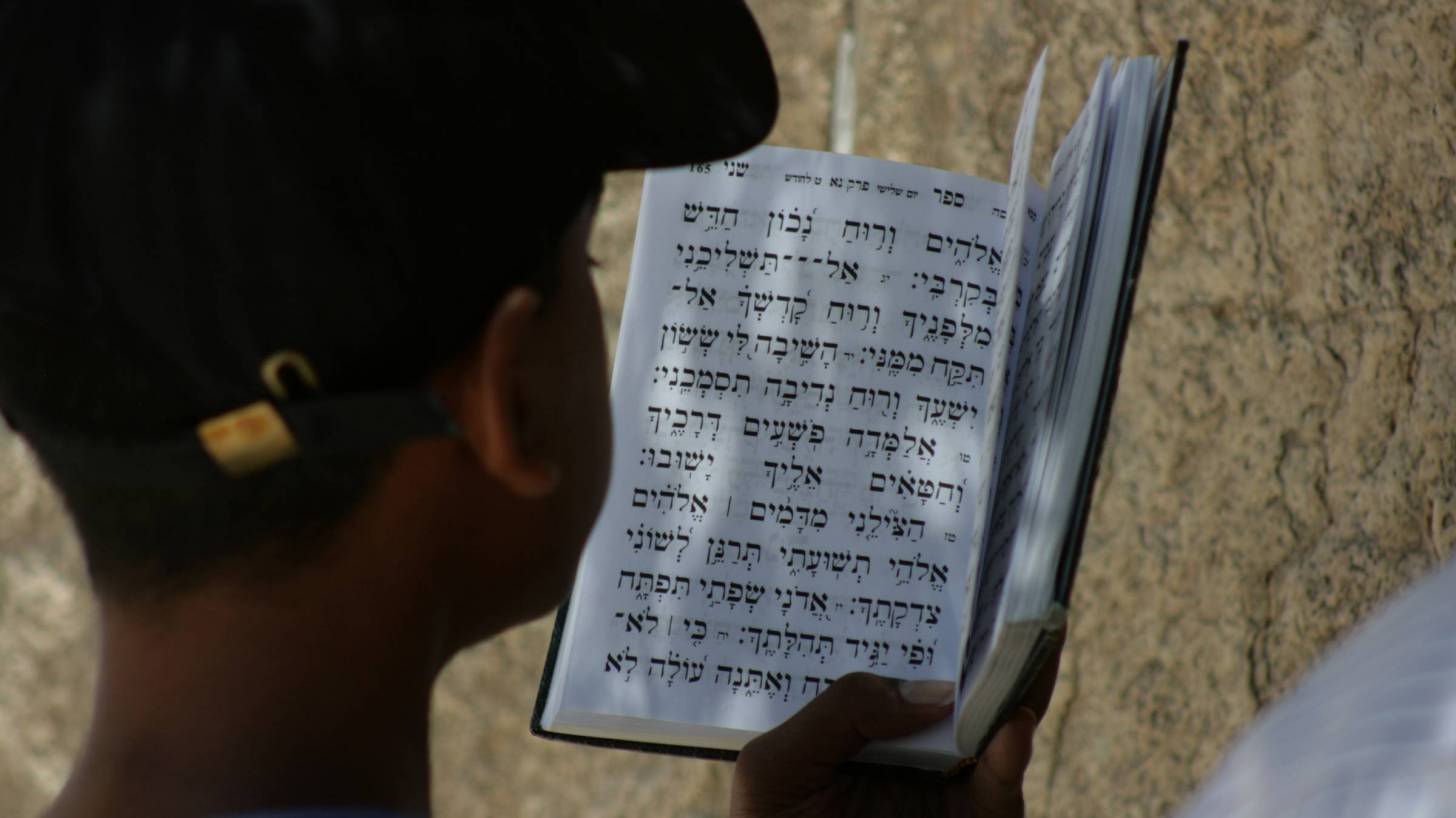 young boy reading prayers