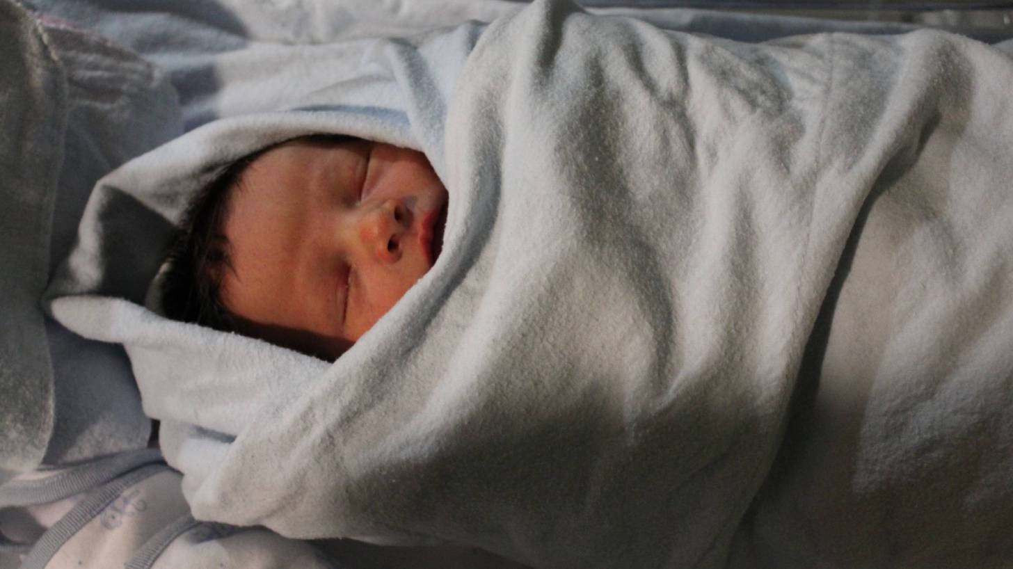 new born baby swaddled in a blanket