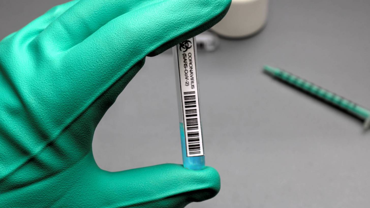 glove holding sars-cov-2 potential vaccine