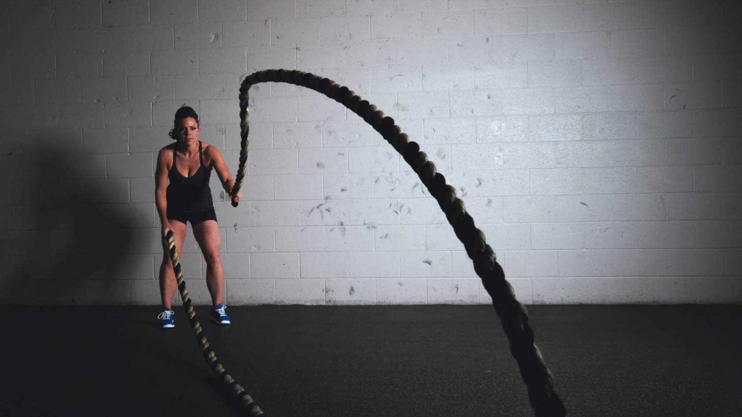 woman training with ropes to get stronger