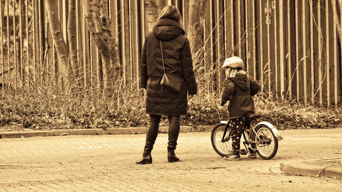 mom and young girl on her bike