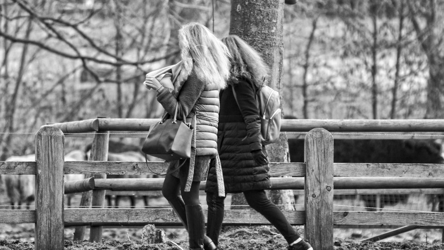 two women walking outdoors