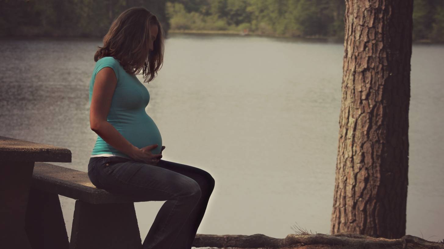 pregnant woman by a lake