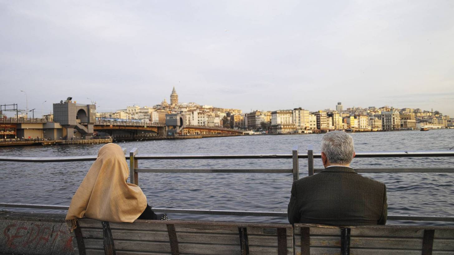 man and woman sitting on a bench