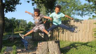 twin boys jumping for joy