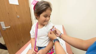 little girl getting a vaccine