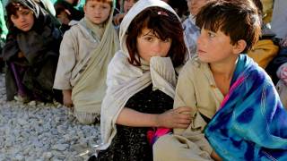 Afghan children sitting in a line 