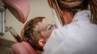 dentist with young boy in the chair