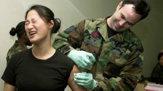 us military service woman getting a vaccination