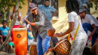 group of people playing african drums celebrating