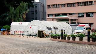 hospital with outside testing tents set up for covid-19