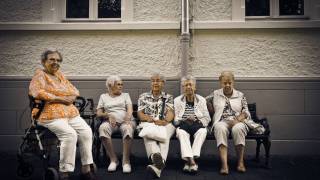 older women sitting on a bench at a retirment home