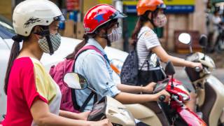 girls on scooters with masks and helmets